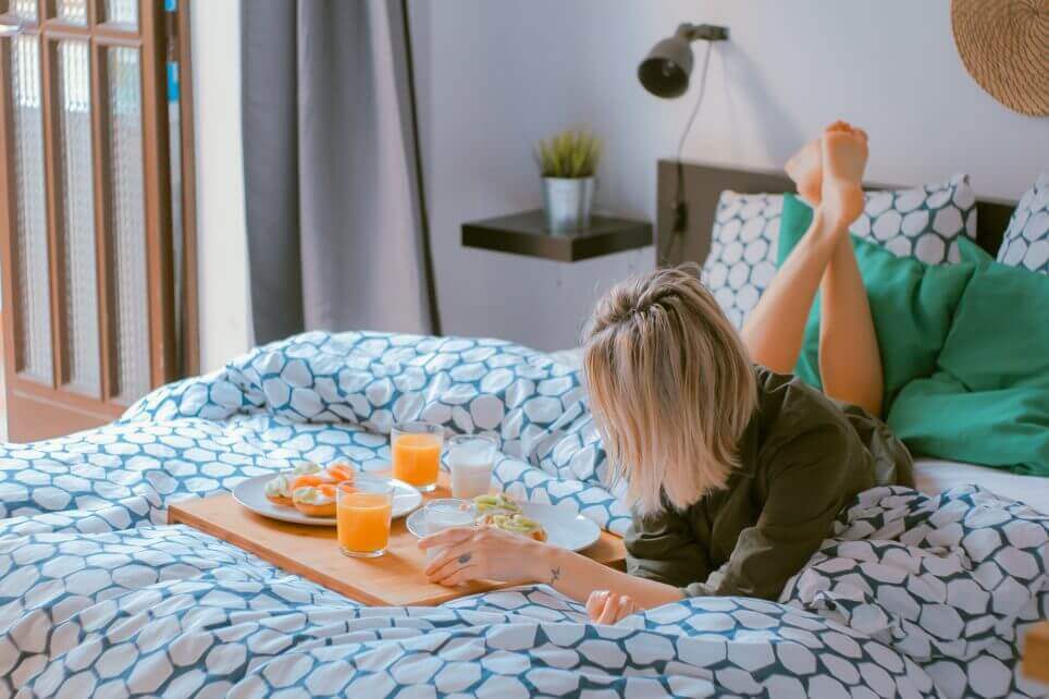 woman chilling with breakfast in bed